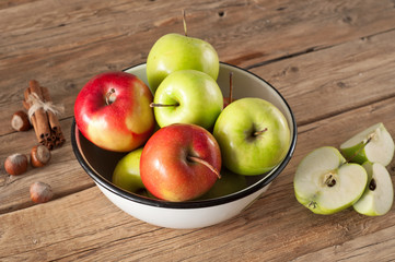 Red and green juicy apples placed in a bowl