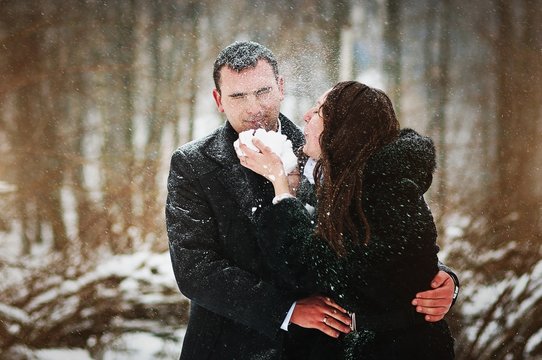 Young loved couple on winter snowy day