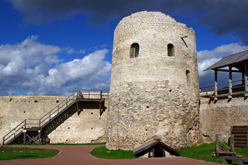 Fototapeta na wymiar Tower and walls of the ancient fortress