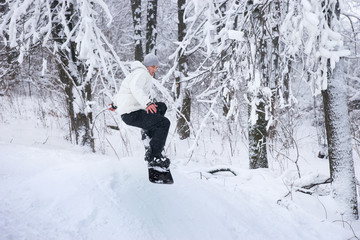 Young man snowboarding in fresh white snow