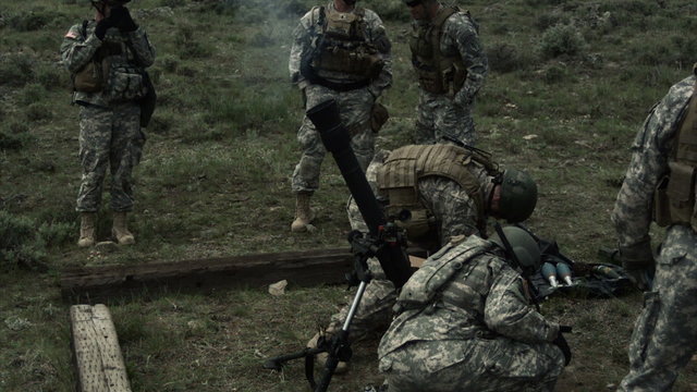 Slow motion clip of soldiers firing a mortar.
