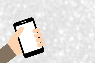 hand holding smart phone over white silver blurred bokeh abstrac