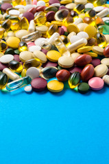 Colorful pills on blue background