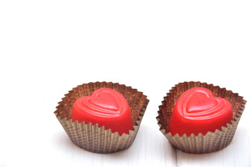 Heart-shaped chocolates on a white background 