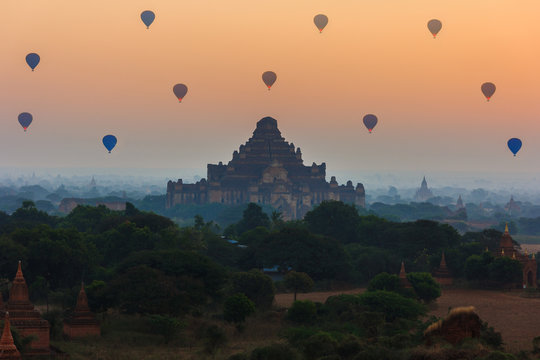 group of ancient pagodas in Bagan with altitude balloons at the