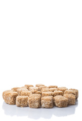 Brown sugarcane sugar cube over white background