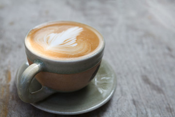 Close-up cup of latte coffee on wooden (Selective focus)