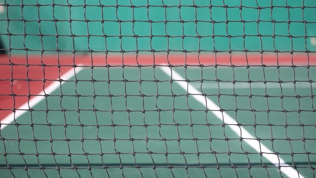 Outdoor tennis net at court with nobody
