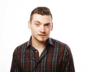 Obraz premium Handsome young man in shirt looking at camera 