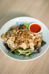 Flat rice noodle stir fried with egg and chicken.