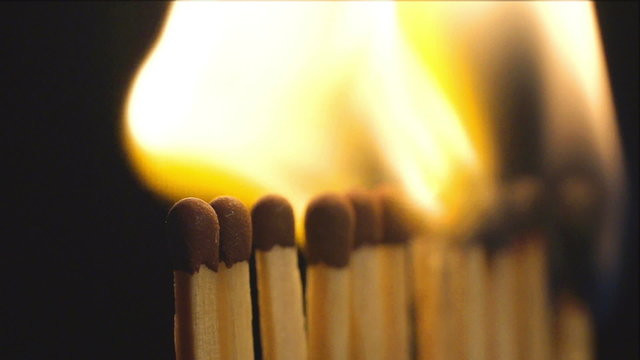 SLOW (240fps): A row of matches are burning in sequence
