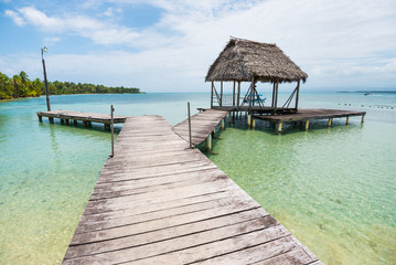Wooden pathway with small hut over Caribbean sea on Bocas del Toro islands in Panama
