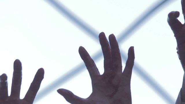 Bloody hands of supernatural creatures stretch towards victim, zombie invasion