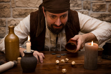 Pirat würfelt an einem mittelalterlichen Tisch, Konzept Glück