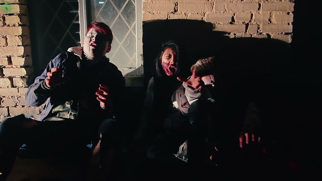 Zombies wake up after transformation, approaching camera with aggressive faces