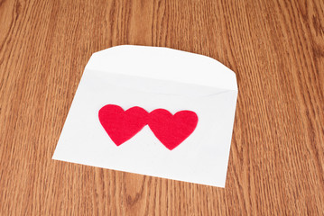 Red heart shape on white envelope