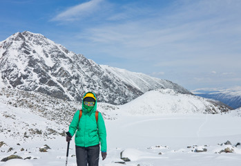 Fototapeta na wymiar A tourist hiking the mountain in the winter