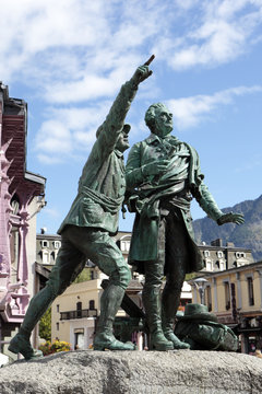 Chamonix France statue in the center of ski resort village town with balmat and assure pointing up at the summit of Mont Blanc photo
