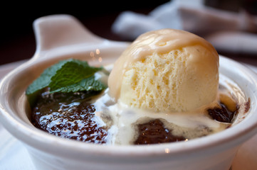 An oozing chocolate lava cake topped with homemade vanilla ice cream.