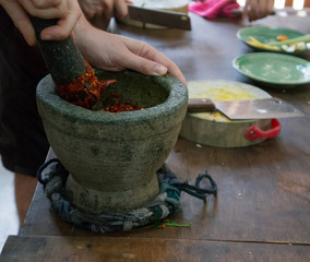 Preparing a traditional red chili paste.