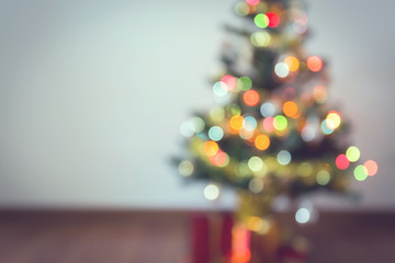 Fototapeta premium blur background, light celebration on christmas tree with gift box in living room