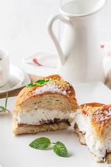 Cream cake with a cup of coffee and jar