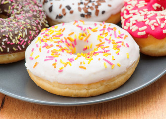 donuts coffee and milk on wooden board