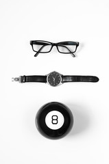 Black and white minimalistic composition: glasses, watches and magic ball 8.