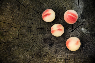 Peaches on a dark vintage wooden background. Top view