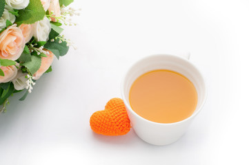 orange heart shape with orange juice and rose on isolated white