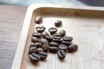 Selective coffee beans prepare for coffee brewing on the wood tray 