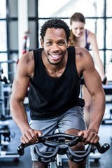 Fit man working out at spinning class
