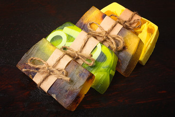 Colorful natural herbal soap related thread lying on a wooden table