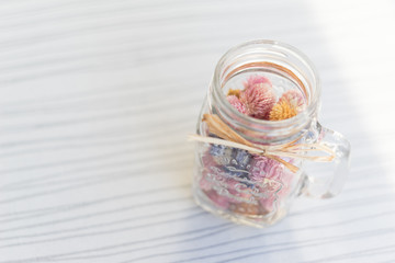 Vial and a small flower
