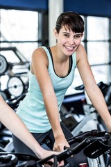 Fototapeta na wymiar Fit woman working out at spinning class
