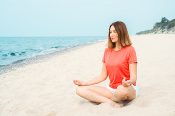Fototapeta na wymiar Woman meditating by the sea
