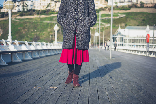 Young woman walking on pier