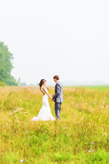 Young happy wedding couple holding hands