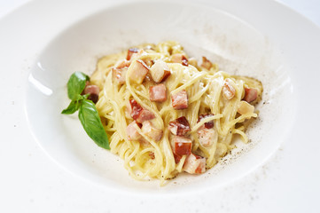 Spaghetti alla Carbonara on white plate studio shot