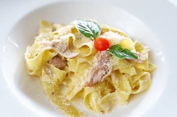 Pasta with rabbit meat on white plate
