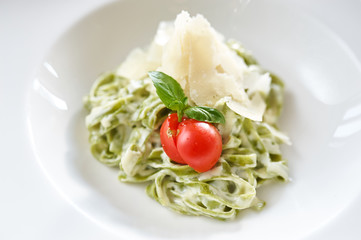 Fettucine Alfredo noodles with parmesan and tomato