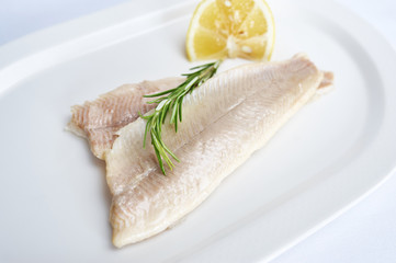 Trout fillet on white plate studio shot
