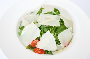 Italian salad on white plate studio shot