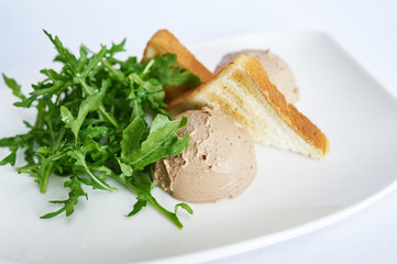 Chicken liver pate on white plate studio shot
