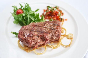 Steak marble on white plate studio shot