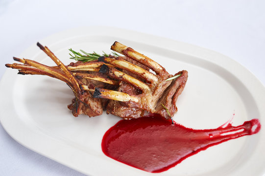 Rack Of Lamb With Raspberry Jam On White Plate Studio Shot