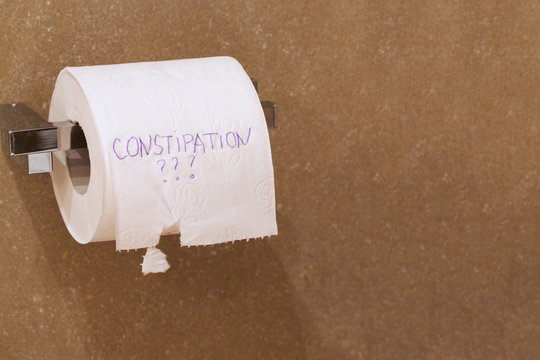 The word constipation written on a tolet paper