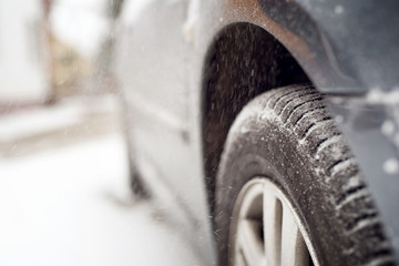 Close up of tire at snow. Winter. Shallow depth of field.