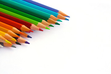 Colourful pencils over white.