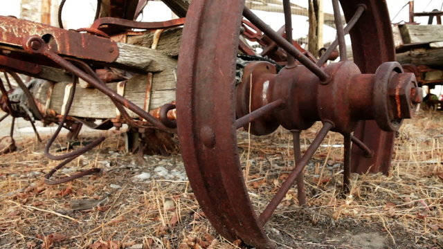 Old, rusted plow abandoned in a field